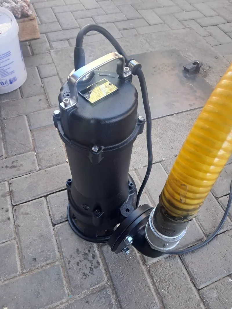 ARPCO's submersible pump standing on paving with its yellow discharge hose coupled to the outlet
